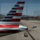 The tail of an American Airlines aircraft sits on a Phoenix runway May 24, 2016, in New York City.
Spencer Platt/Getty Images